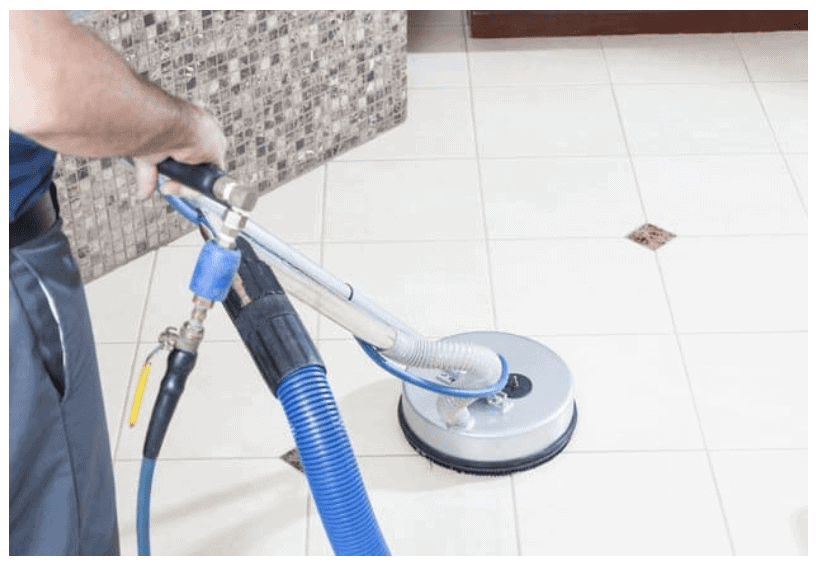man holding a tile and grout cleaning tool