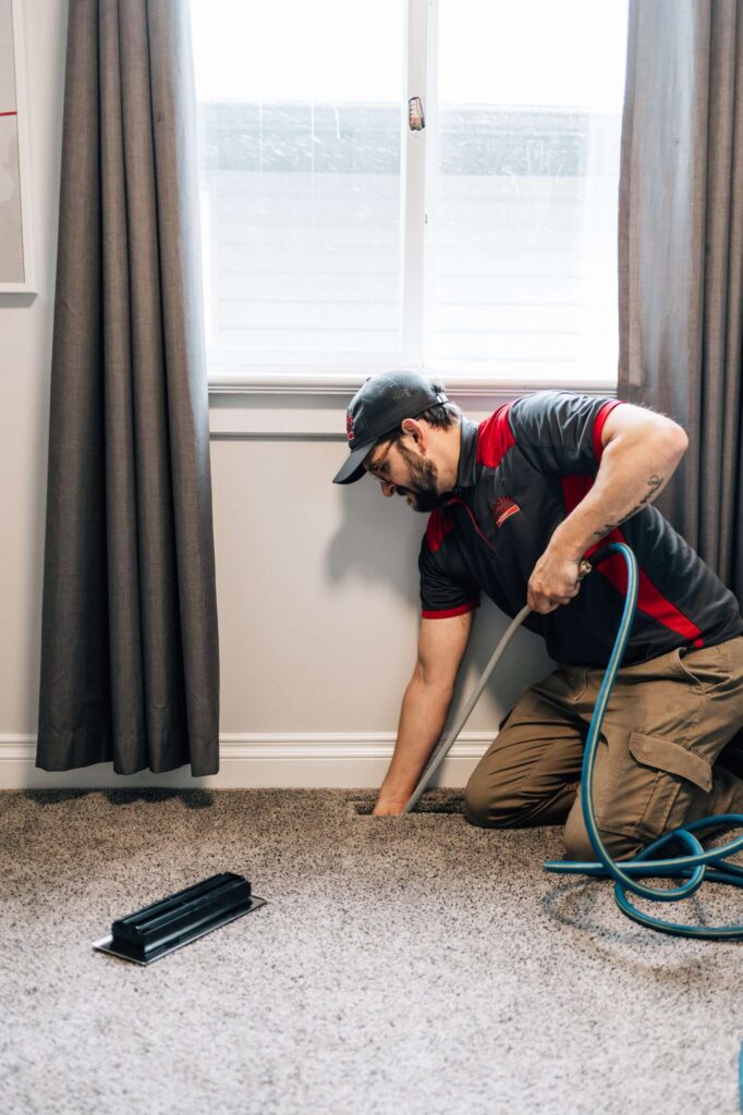 Professional in Calgary cleaning ducts and vents