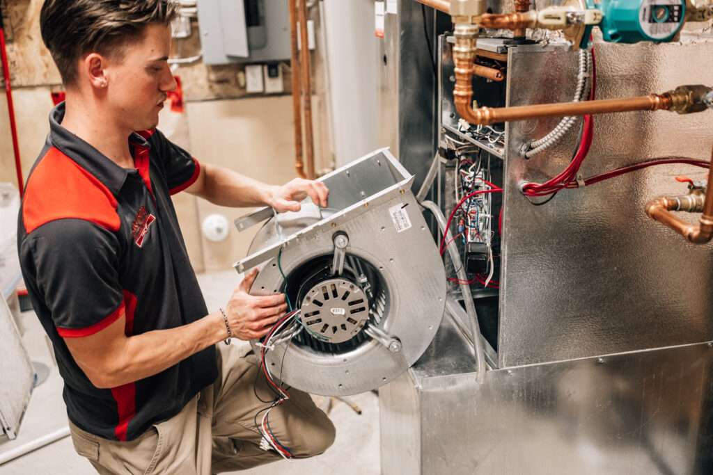Expert technician performing furnace and duct cleaning to improve indoor air quality in a Calgary home.